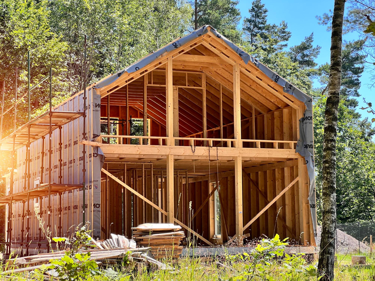 Construction of timber frame house in the woods