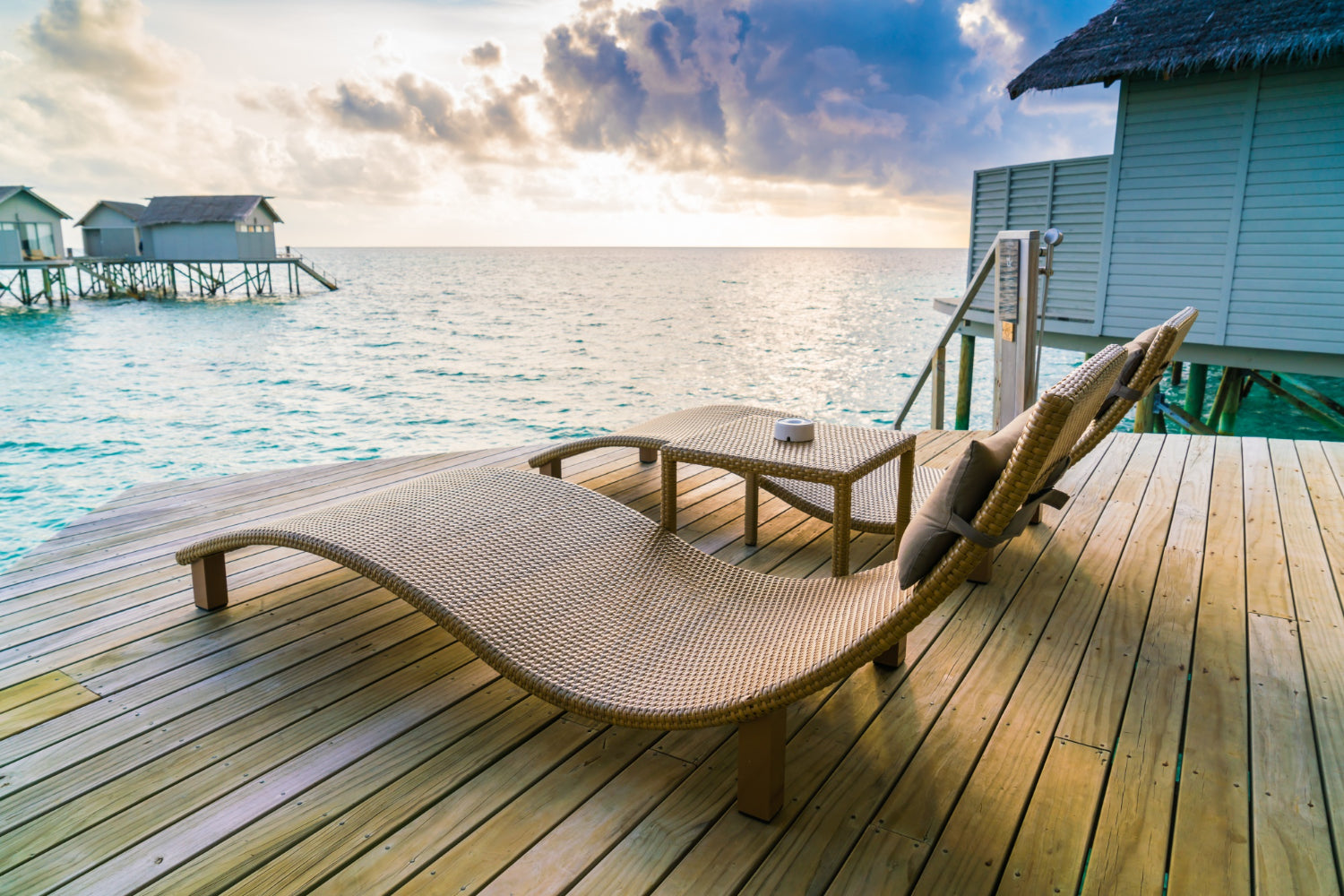 wicker loungers on a pine neck on deck overlooking the ocean